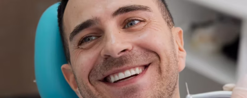 a smiling man with white teeth